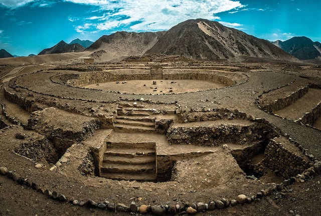 ancient ruin of Caral from above with mountain in background ancient ruin of Caral from above with mountain in background