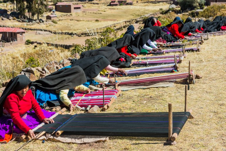 PUNO, PERU - JULY 25, 2013: women weaving in the peruvian Andes at Taquile Island credit shutterstock PUNO, PERU - JULY 25, 2013: women weaving in the peruvian Andes at Taquile Island credit shutterstock