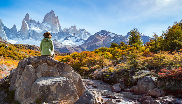 a hiker rests on a rock in Patagonia a hiker rests on a rock in Patagonia