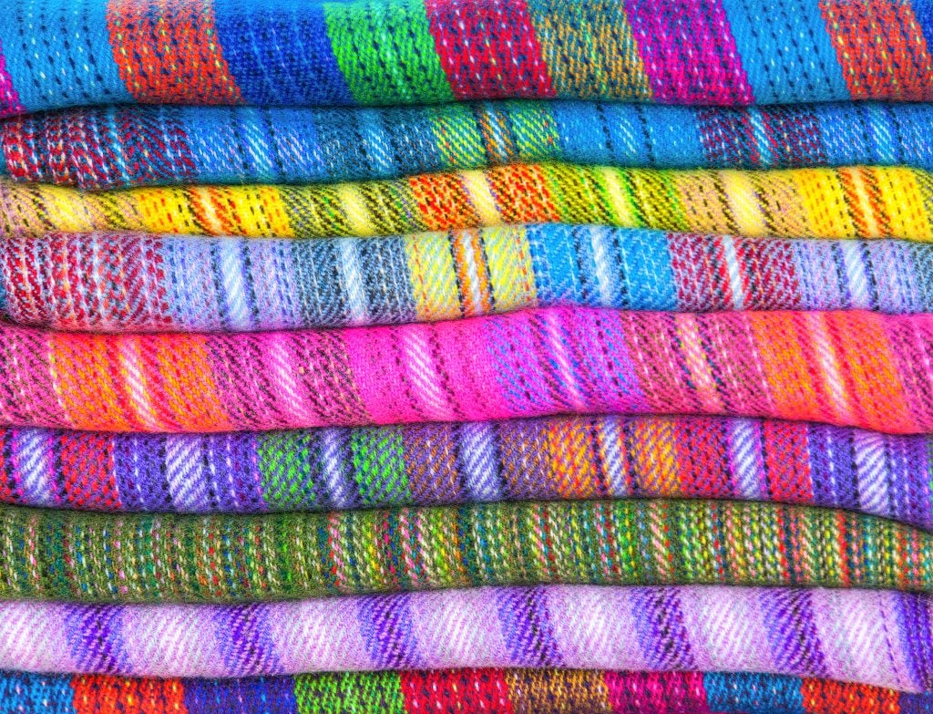 A pile of brightly coloured fabrics of wool lama and alpaca in market Uyuni, Peru, Latin America Credit: Shutter stock A pile of brightly coloured fabrics of wool lama and alpaca in market Uyuni, Peru, Latin America Credit: Shutter stock