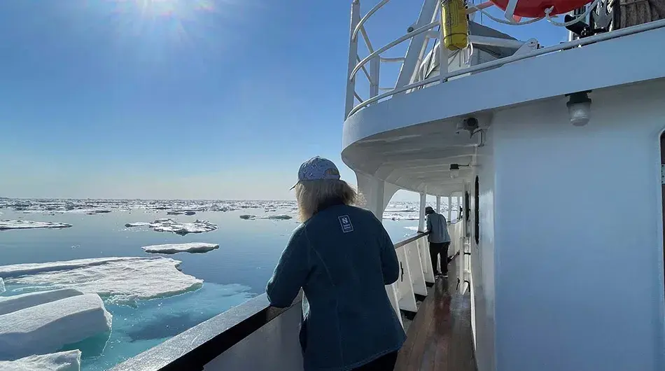 MS Sjoveien - Arctic Cruising MS Sjoveien - Guest out on deck sailing in the Arctic