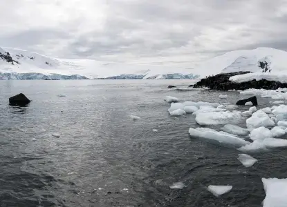 Antarctica_Mikkelsen-Harbour_icy-shoreline-hero.jpg Icy shoreline in Mikkelsen Harbour in Antarctica with snowy mountains)